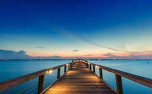 Stroll along the pier, taking in the tranquil atmosphere and breathtaking views of the calm waters.