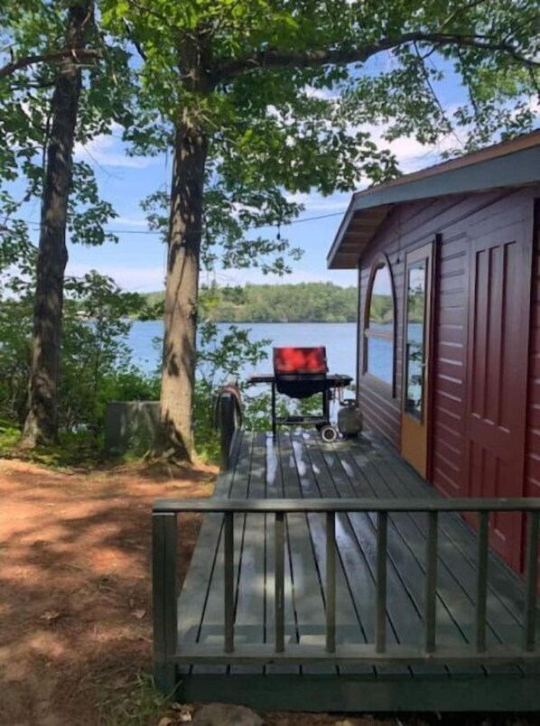 Enjoy al fresco dining on the deck with a grill and barbecue, taking in the serene views of the lake.