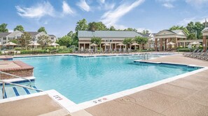 Relax by the pool surrounded by comfortable lounge chairs and umbrellas.