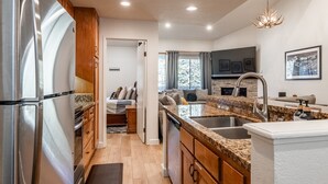 A modern kitchen with granite countertops, stainless steel appliances, and a built-in oven. - Bacta Haus 3br/3ba+Loft walk to Village & Canyon (Mammoth Lakes)
