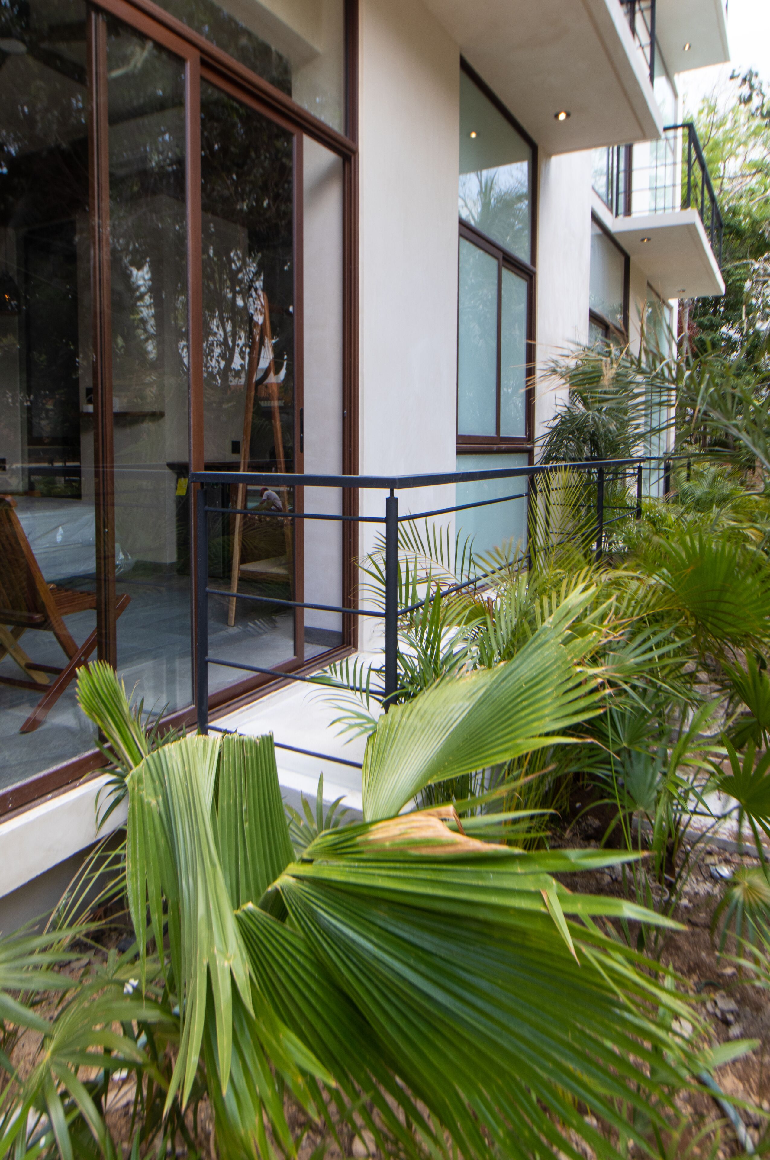 A modern house with large glass doors and a balcony.
