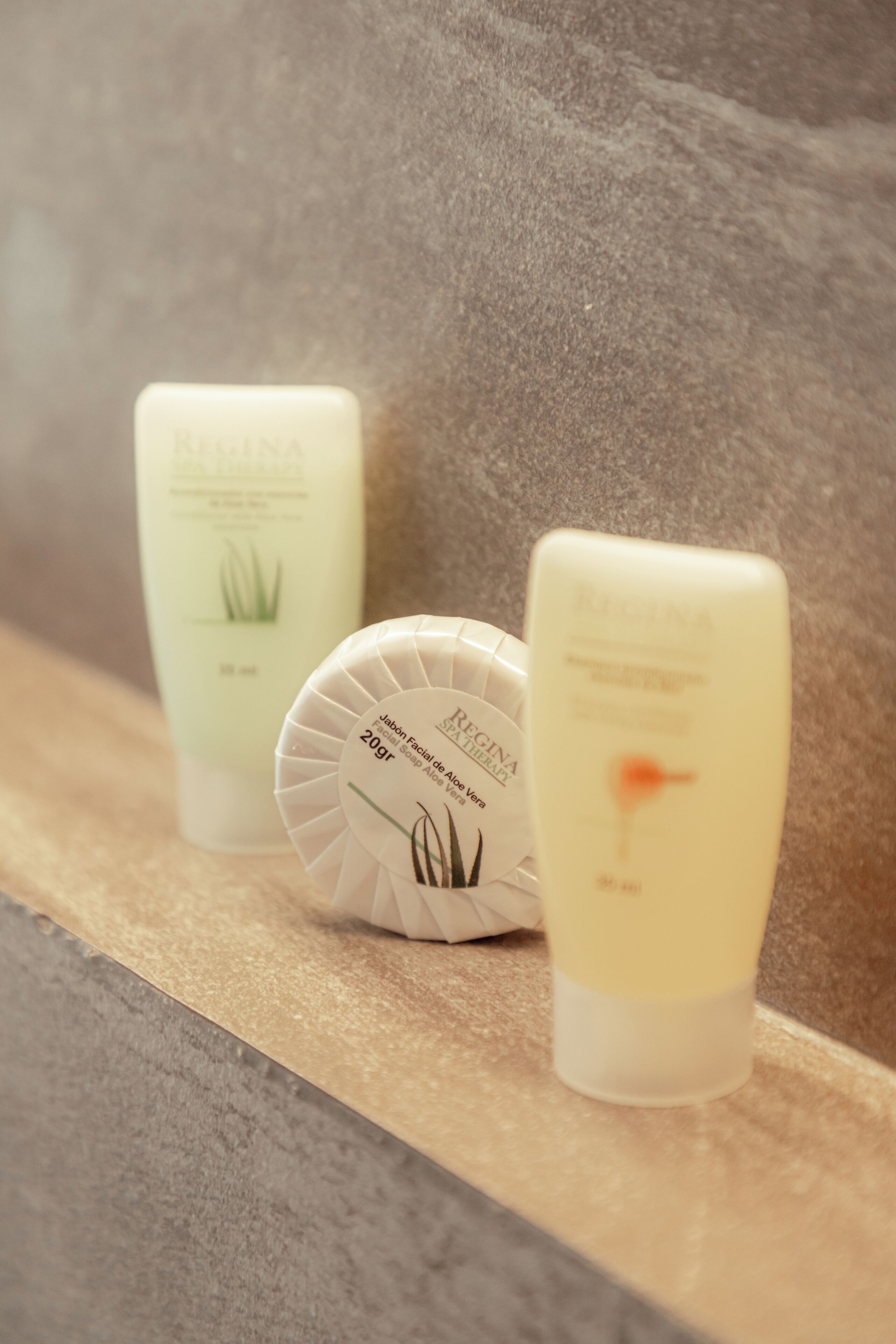 Three skincare products on a shelf.
