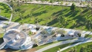 An aerial view of a modern building with a circular central structure surrounded by landscaped areas and pathways. - BeachFront On The Sand Unit #227 South of 5th, 335 Ocean Dr, Miami Beach (Miami Beach)