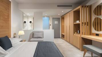 A modern hotel room with a bed, bedside table, lamp, chair, and a wooden wardrobe with circular mirrors.