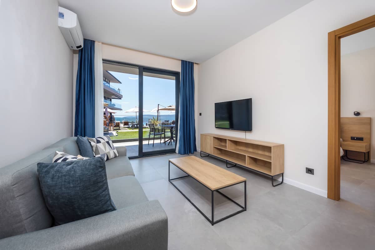 Family Apartment, Sea View | Living area | 42-inch LED TV with satellite channels