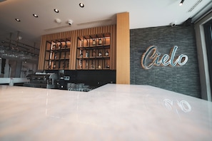 Cielo offers a stylish space with a bar area and a staircase leading to more rooms.