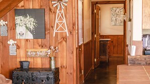 A wooden interior with a sign reading "Country House," a windmill decoration, and a vintage suitcase. - Spacious Vacation Home with Great Outdoor Amenities (Concan)