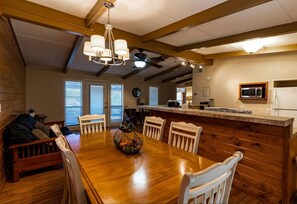 Enjoy meals in this dining area with a wooden table and comfortable chairs.