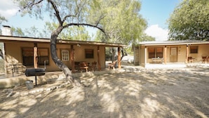 A rustic cabin with a covered patio, outdoor seating, and a barbecue grill. - Walking distance to the Frio River, access to shared pool (Concan)