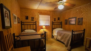 A room with two metal bunk beds, wooden walls, a ceiling fan, and a window with blinds. - Walking distance to the Frio River, access to shared pool (Concan)