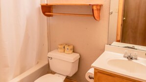 A bathroom with a toilet, sink, and shower. - Frio Country Resort - Within walking distance to the Frio River! (Concan)