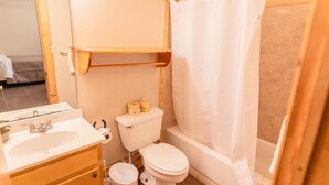A bathroom with a toilet, sink, and bathtub. - Frio Country Resort - Within walking distance to the Frio River! (Concan)