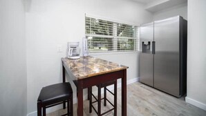 A kitchen with a marble countertop, a coffee maker, and a stainless steel refrigerator. - CENTRAL JACKSONVILLE WORK STAY NEAR I-295 (Jacksonville)