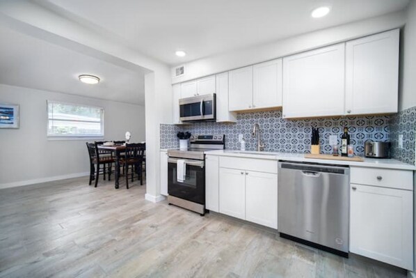 Enjoy cooking in this well-equipped kitchen with a microwave, oven, and dishwasher, and dine at the adjacent table.