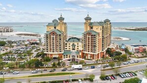 Ein Hotel mit zwei markanten Türmen, Blick auf den Strand und einem Parkplatz.