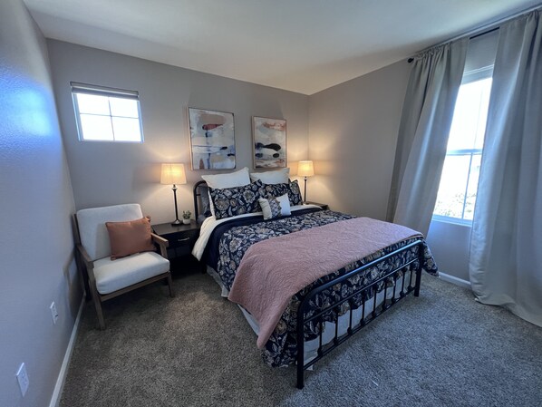 A bedroom with a bed, bedside tables, a chair, and artwork on the walls. - Folsom Escape is your personal getaway and retreat close to Folsom Lake. (Folsom)