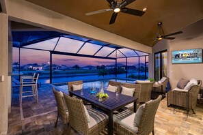 Outdoor dining - Foosball, Outdoor Grilling Station, Pool and Spa, Canal Views - Salted Air Villa - Roelens Vacations (Cape Coral)