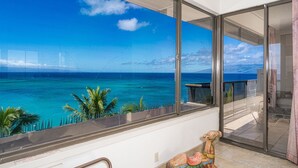 A balcony with a view of the ocean and a distant bridge. - MILLION DOLLAR VIEW!!  2 BDRM OCEANFRONT CONDO WEST MAUI. NEW AC IN EVERY ROOM. (Lahaina)