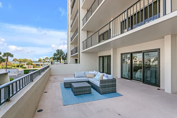 Relax on a contemporary sofa set amidst a serene landscaped garden view.