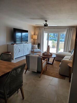 Relax in a stylish living space with a flat-screen TV, comfortable seating area, and dining table.