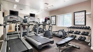 A gym with treadmills, weight machines, and a bench. - Nautical Adventure Awaits in Annapolis Suites! Pets Allowed Here! Free Breakfast (Annapolis)