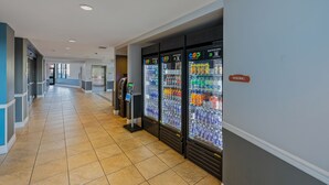 A hotel corridor with vending machines and a 'VENDING' sign. - Coachella Shuttle, Lazy River: 3BR in Resort (Indio)