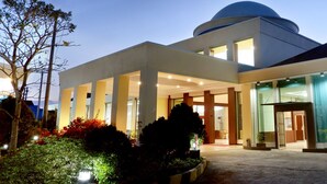 A modern building with a large dome and a spacious entrance area. - Sahid Azizah Syariah Hotel & Convention (Kendari)