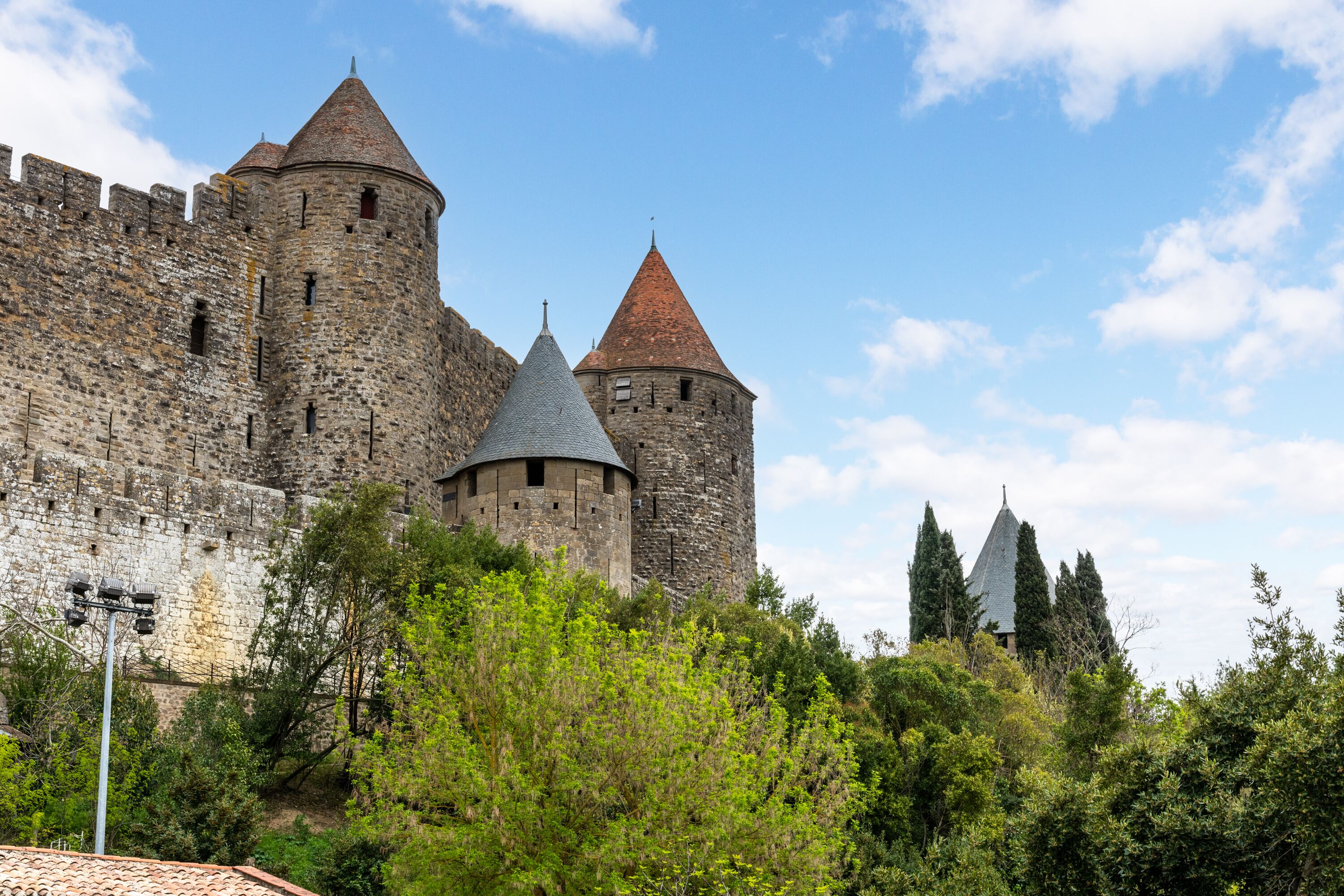 A historic stone castle with multiple towers and a fortified wall.