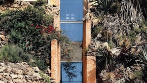 A stone building with a sign reading 'CASTILLO DE SANTA CLARA' and a gated entrance. - Studio Apartment 'Casa Pedro Santa Clara' with Sea View, Pool, and Wi-Fi (Torremolinos)