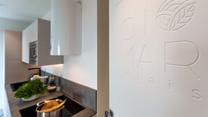 Eine moderne Küche mit weißer Arbeitsplatte, einem Spülbecken und einem Blumentopf.