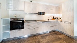A modern kitchen with built-in appliances, a stainless steel oven, and a microwave. - Apartment "Haus Reimon Monika" with Mountain View & Wi-Fi (St.Leonhard in Passeier)