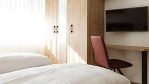 A bedroom with a bed, a chair, a TV, and wooden walls. - Apartment "Kleon 2" with Mountain View, Shared Pool and Wi-Fi (Riffian)