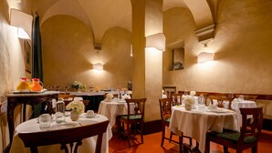 Un restaurant avec des tables et des chaises rondes, et un intérieur chaleureux.