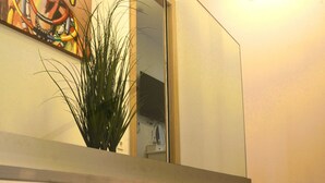 A modern interior with a staircase, a large mirror, and a painting on the wall. - Three bedroom villa with pool (Malinska)