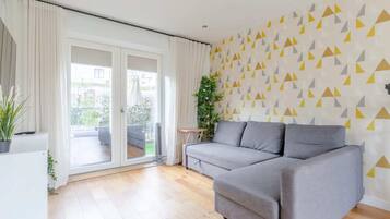 Basic House, Multiple Beds | Living area | TV