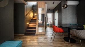 A modern interior with a staircase, a dining area, and a kitchen. - Onyx Luxury Budapest (Budapest)