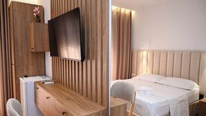 A hotel room with a wooden desk, a flat-screen TV, a bed with a headboard, and a nightstand. - VILA AARON (Durrës)