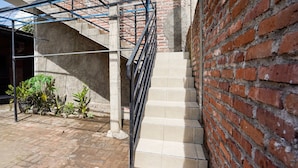 A staircase with beige steps leading up to a brick wall. - OYO 91827 Tutus Homestay Syariah (Pasuruan)