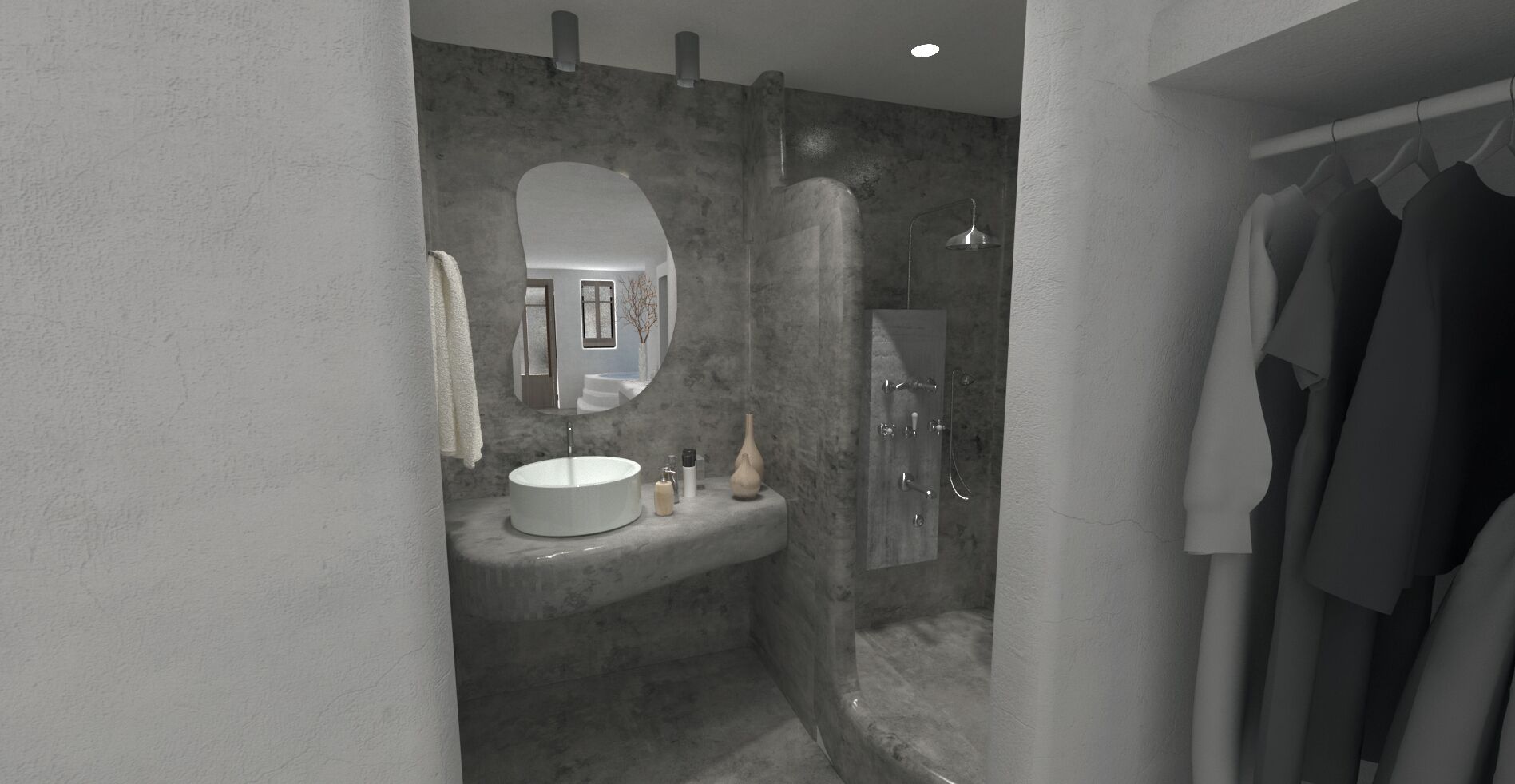 Un baño moderno con un lavabo redondo, un espejo, ducha y perchero.