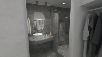 Un baño moderno con un lavabo redondo, un espejo, ducha y perchero.