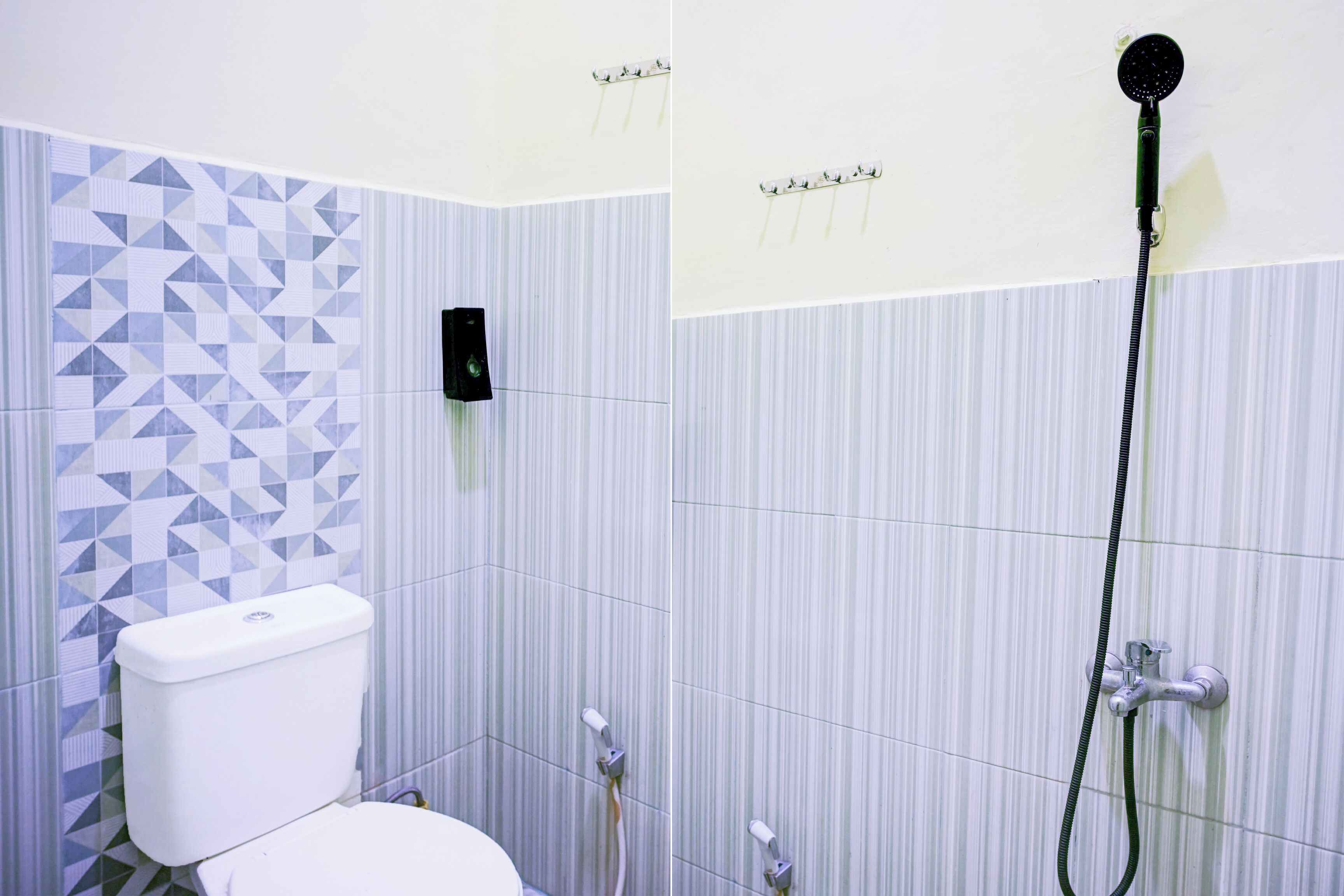 A bathroom with a toilet, a shower, and a wall-mounted speaker.