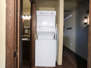 Compact laundry room with washer and dryer.