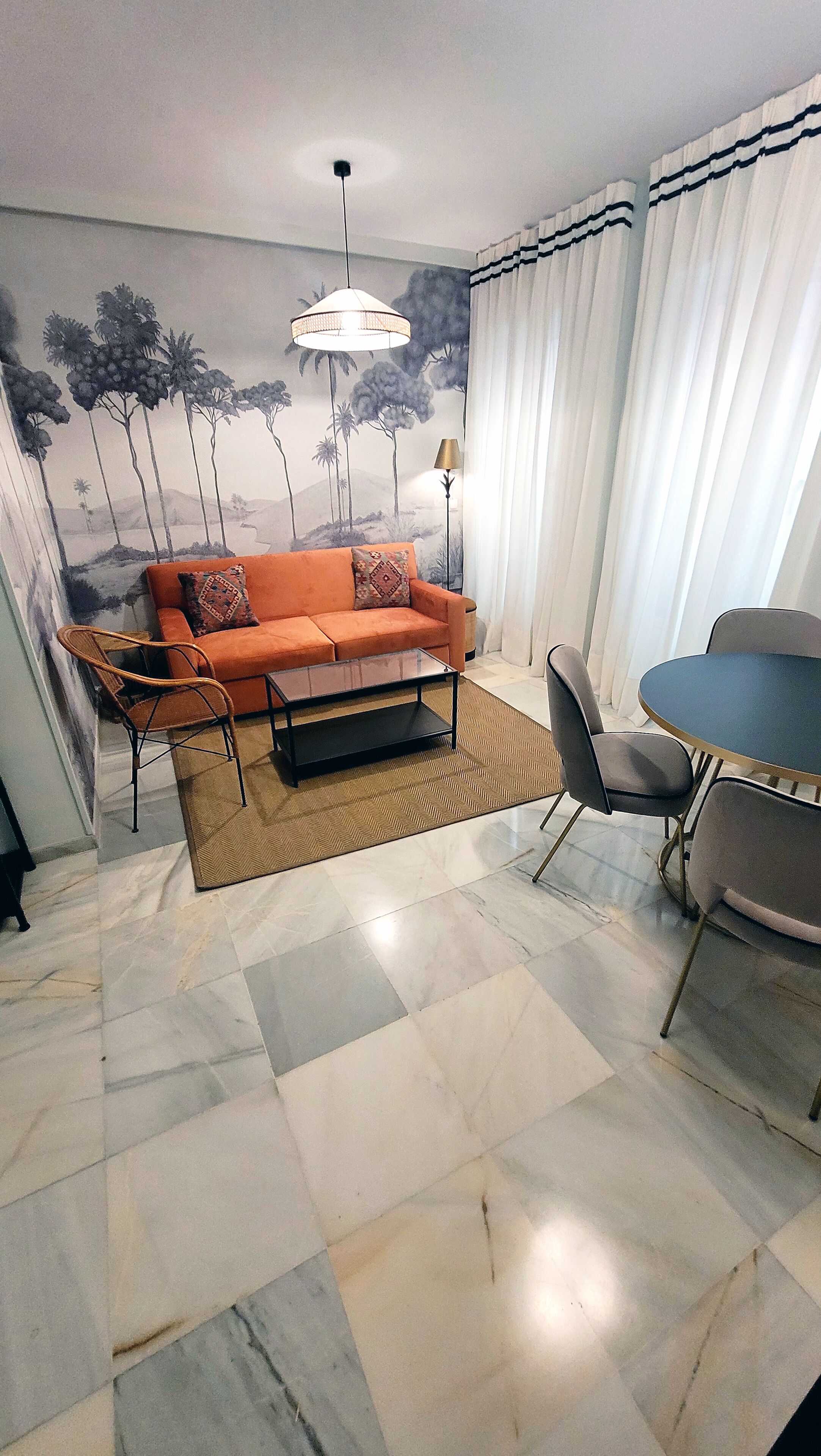 Una sala de estar con sofá, mesa de centro y comedor.
