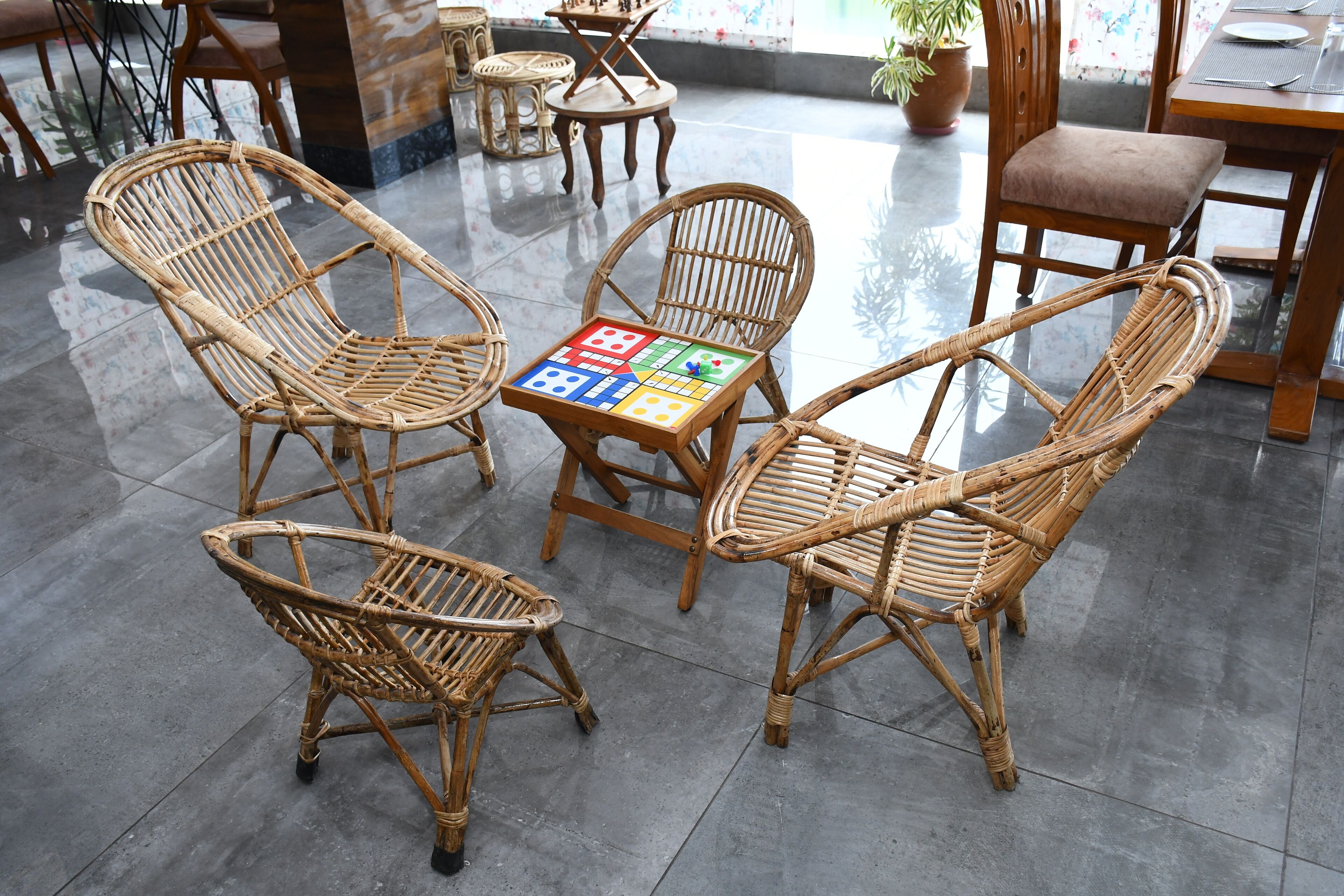 Wicker chairs arranged around a table with a board game.