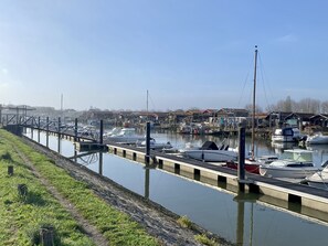 Stroll along the marina, surrounded by moored boats and a serene atmosphere.