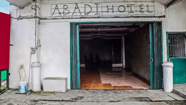 The exterior of ABADI HOTEL with a sign above the entrance, a tiled entrance, and a visible door. - Hotel O Abadi Hotel (Medan)