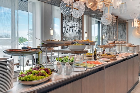 A buffet with various food items and a modern interior design.