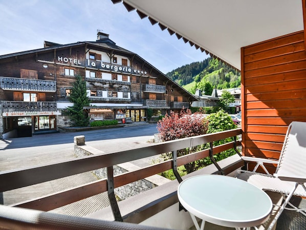 A wooden building with balconies and a sign reading 'HOTEL la bergerie.'