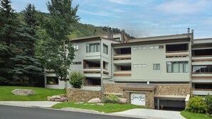 A multi-story building with a stone facade, a garage, and a sign that reads "Snow Fox."