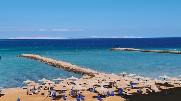 On the beach, sun loungers, beach towels
